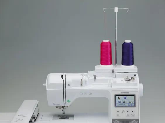 Brother sewing and embroidery machine with dual thread spools in pink and purple