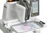 Brother embroidery machine with touchscreen displaying colorful mermaid design on fabric