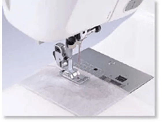 Brother sewing machine needle and presser foot stitching white fabric
