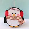 Penguin-shaped holiday cup with red earmuffs, striped scarf, and white straw
