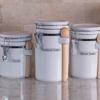 Brother TZe label on white kitchen canister with wooden spoon for organized pantry storage