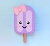 Purple popsicle-shaped cold pack with pink polka dot bow and wooden stick
