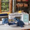 Brother Stellaire embroidery machine stitching character designs on denim jacket in home workspace