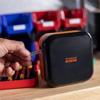 Brother P-touch EDGE label maker with carrying case on workbench with storage bins