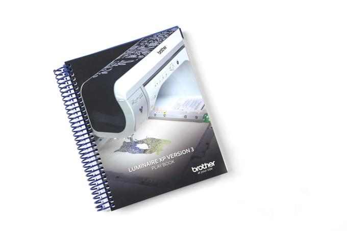 Brother Luminaire XP3 embroidery machine playbook with spiral binding and decorative stitching samples