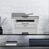 Brother MFCL2759DW monochrome laser all-in-one printer on modern office shelf