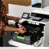 Person replacing toner cartridge in Brother HL-L9410CDN color laser printer with touchscreen