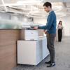 Man using Brother MFC-L6915DW monochrome laser all-in-one printer in modern office