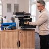 Man replacing toner cartridge in Brother all-in-one color laser printer in office