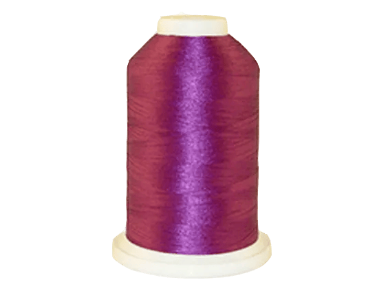 Brother embroidery thread spool in vibrant purple with white cap on transparent background
