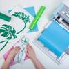 Brother SDX125e cutting machine creating vinyl leaf designs on craft mat
