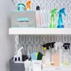 Organized cleaning supplies on white shelves with spray bottles, wipes, and storage containers