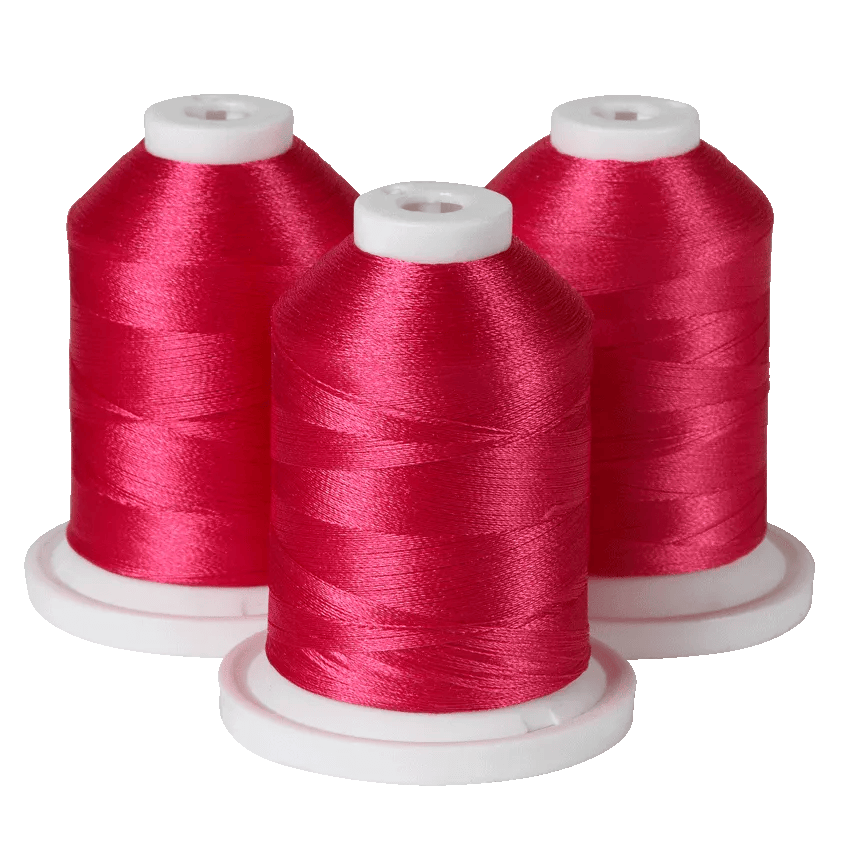 Three spools of red embroidery thread on white bases for Brother sewing machines