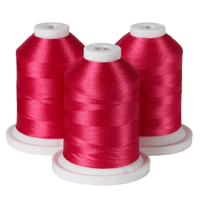 Three spools of red embroidery thread on white bases for Brother sewing machines