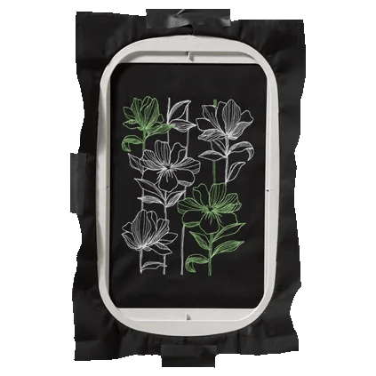 Brother embroidery hoop with floral design stitched on black fabric