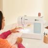 Woman using Brother CP60X sewing machine with digital display and built-in stitches