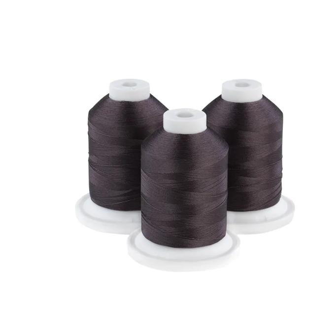 Three charcoal embroidery thread spools on white bases