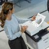 Woman reviewing business growth chart printed from Brother monochrome laser all-in-one printer