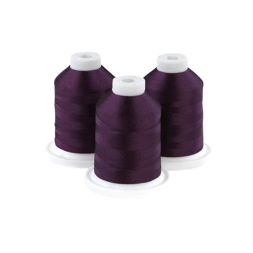 Brother embroidery thread spools in midnight grape purple on white bases