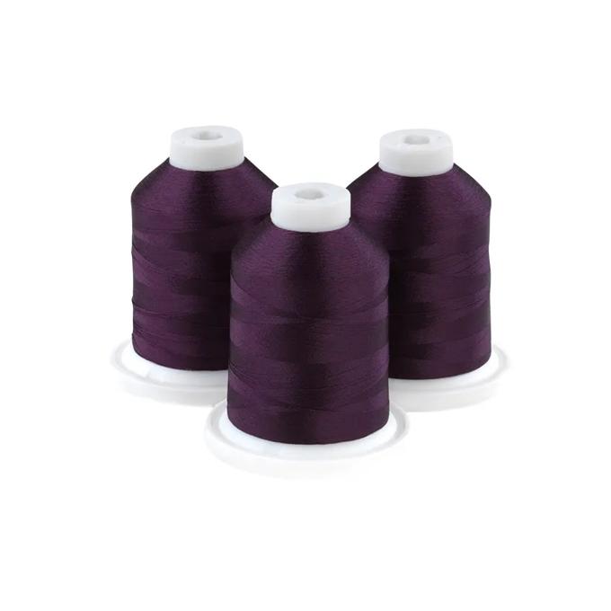 Brother embroidery thread spools in midnight grape purple on white bases
