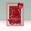 Valentine's Day gift box with red candies and heart-shaped decorations