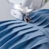 Brother sewing machine stitching blue fabric with presser foot detail