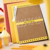 Brother TZe label tape on scrapbook with colorful decorative border and yellow accents