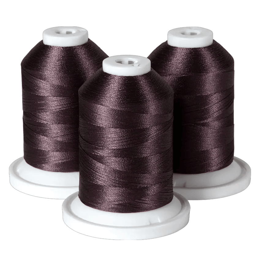Three spools of dark brown embroidery thread on white bases