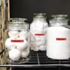 Three glass jars with Brother TZe-421 red laminated labels on wire shelf