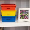 Labeled storage bins with Brother P-touch labels for playroom organization