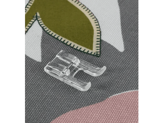 Brother sewing machine presser foot on fabric with decorative stitching detail