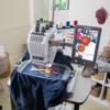 Brother PR680W embroidery machine with touchscreen stitching floral design on denim jacket