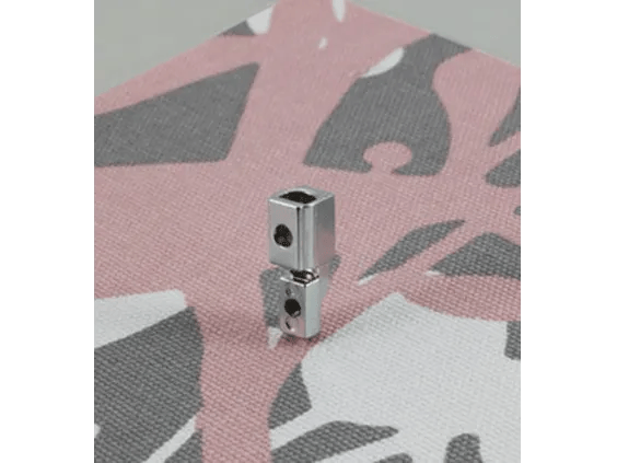 Brother sewing machine presser foot on pink and gray patterned fabric
