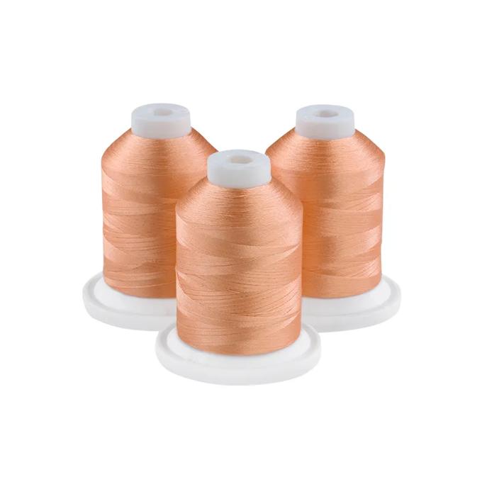 Three spools of tawny port embroidery thread on white bases