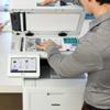 Man scanning documents on Brother MFC all-in-one color laser printer with touchscreen