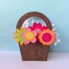 Paper craft basket with colorful flowers in pink, orange, and green on blue background