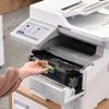 Hand replacing toner cartridge in Brother MFC-L6915DW all-in-one laser printer