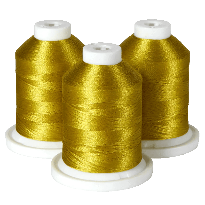 Three spools of gold embroidery thread on white bases