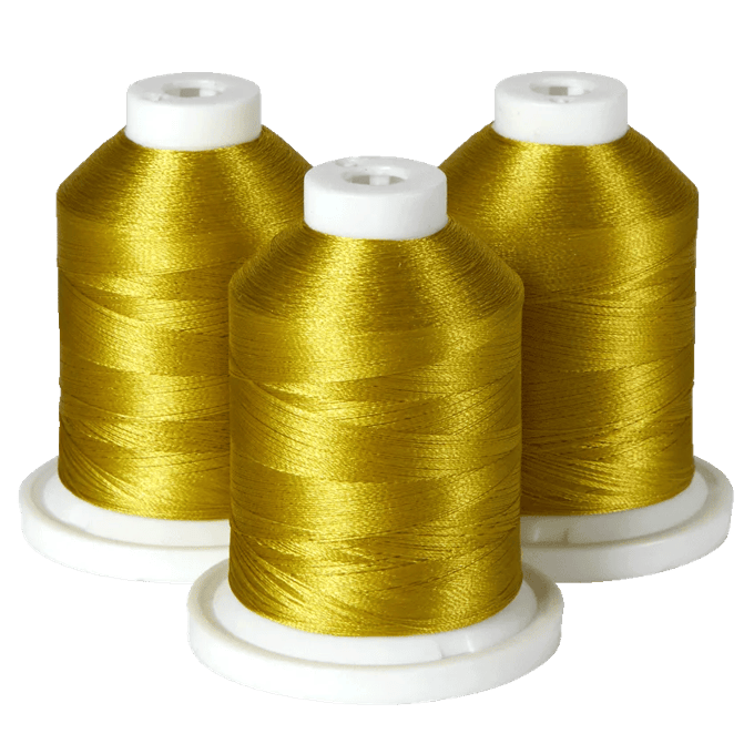 Three spools of gold embroidery thread on white bases
