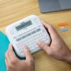 Brother P-touch handheld label maker with QWERTY keyboard printing office organization labels