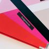 Colorful folders with black label reading Assignments on pink folder
