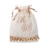 White drawstring bag with rose gold monogram embroidery and beaded trim