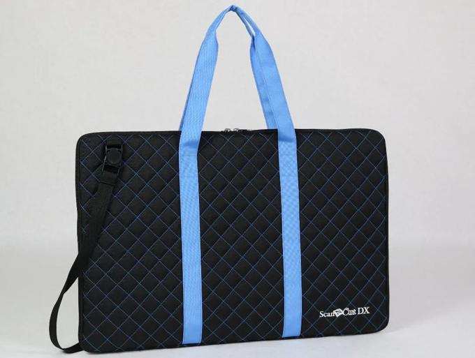 Brother ScanNCut DX portable cutting machine in quilted black carrying case with blue handles