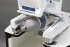 Brother Entrepreneur Pro X embroidery machine with cap frame attachment and gray baseball cap