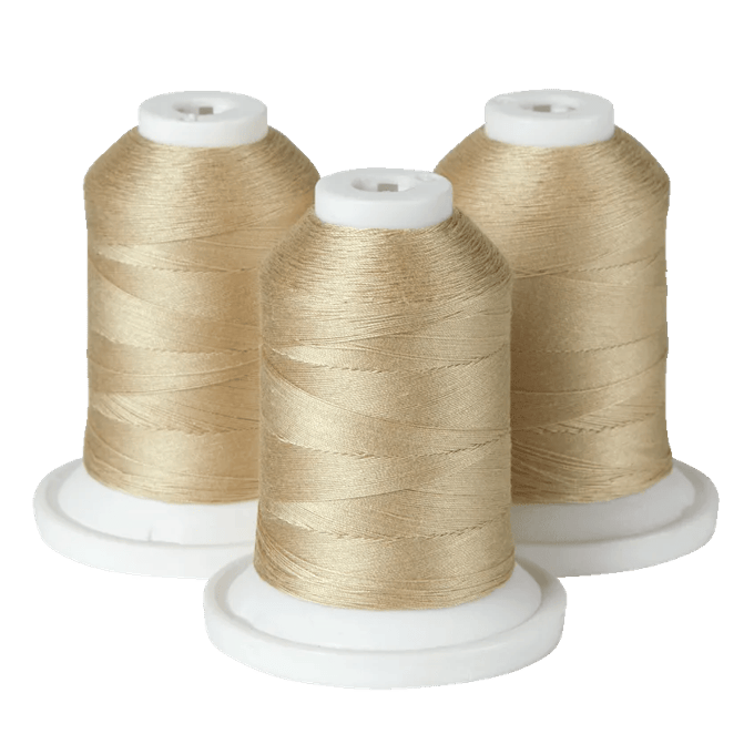 Three spools of gold embroidery thread on white bases for Brother sewing machines