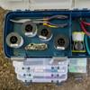 Brother TZe-231 laminated label tape spools organized in blue tackle box with fishing tools
