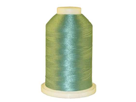 Brother embroidery thread spool in iridescent blue-green with glossy finish on beige base