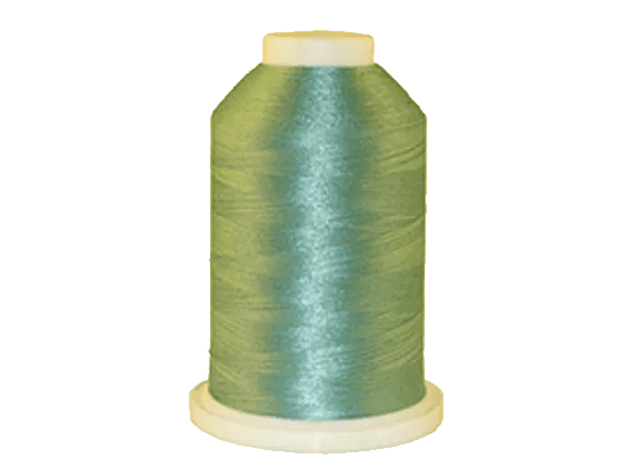 Brother embroidery thread spool in iridescent blue-green with glossy finish on beige base
