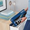 Person placing Brother TN770 high-yield toner cartridge into home office storage drawer