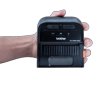 Hand holding Brother RJ-3035 portable thermal printer with yellow label printing